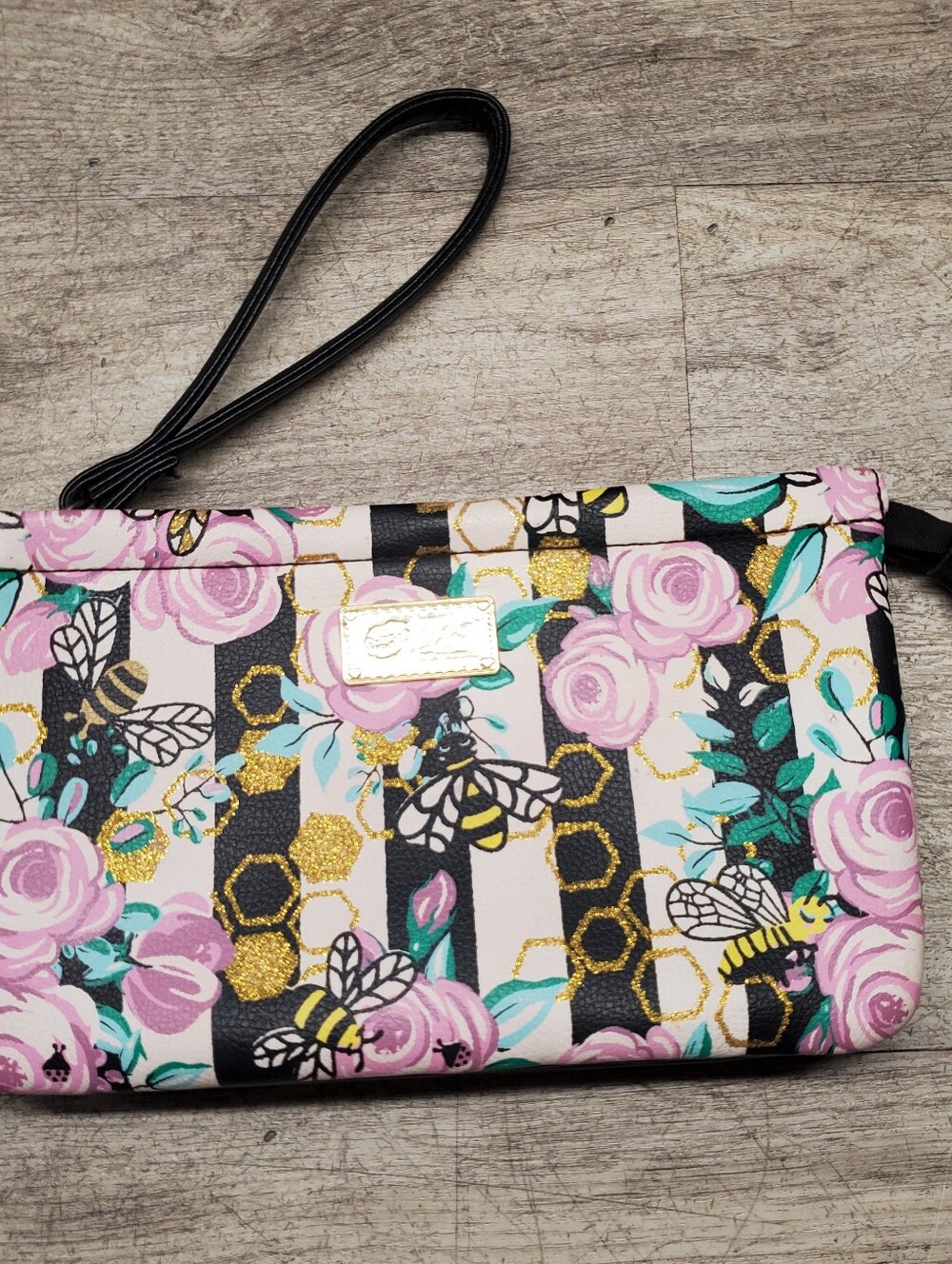 Betsey Johnson wristlet with bee/floral design